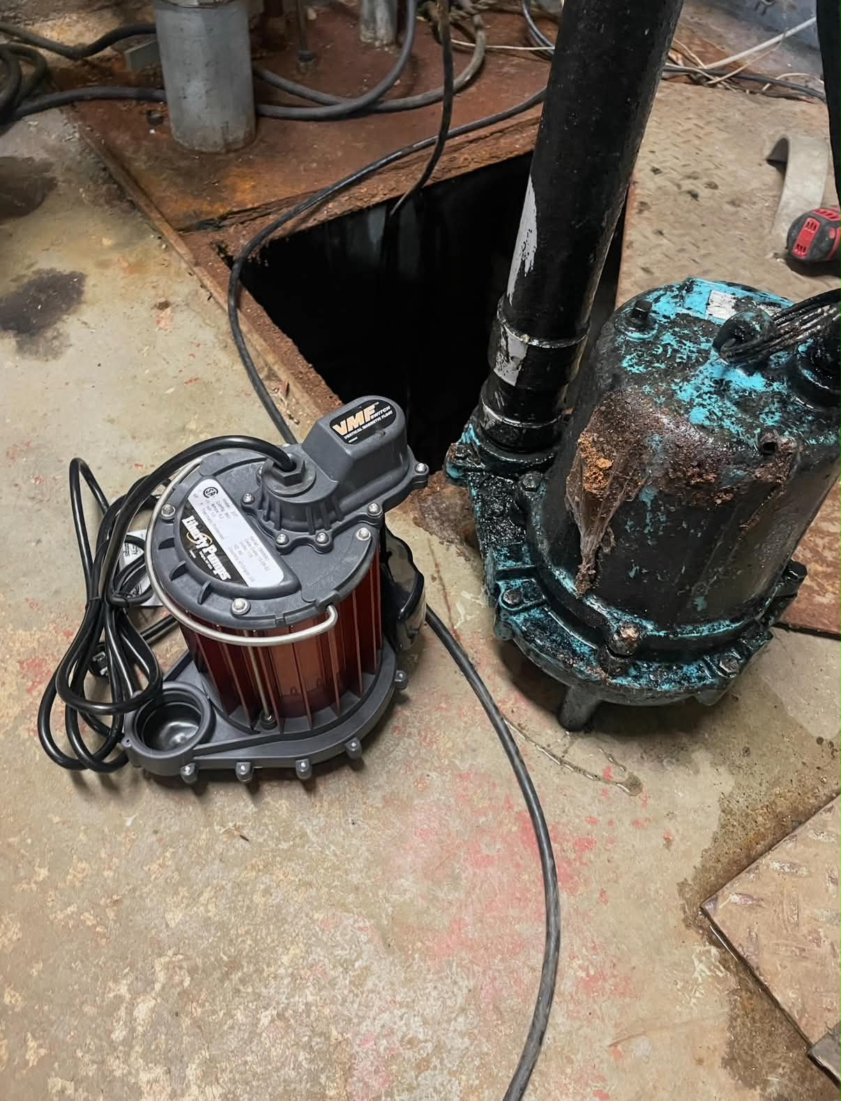 New sump pump beside the pump being replaced